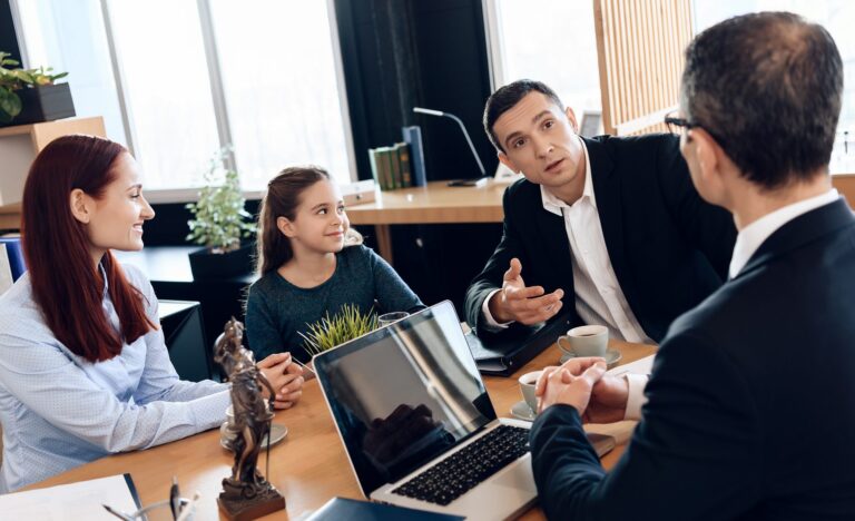 Adult Father, Red Head Mother and Little Smiling Daughter Are Sitting in Lawyer’s Office.